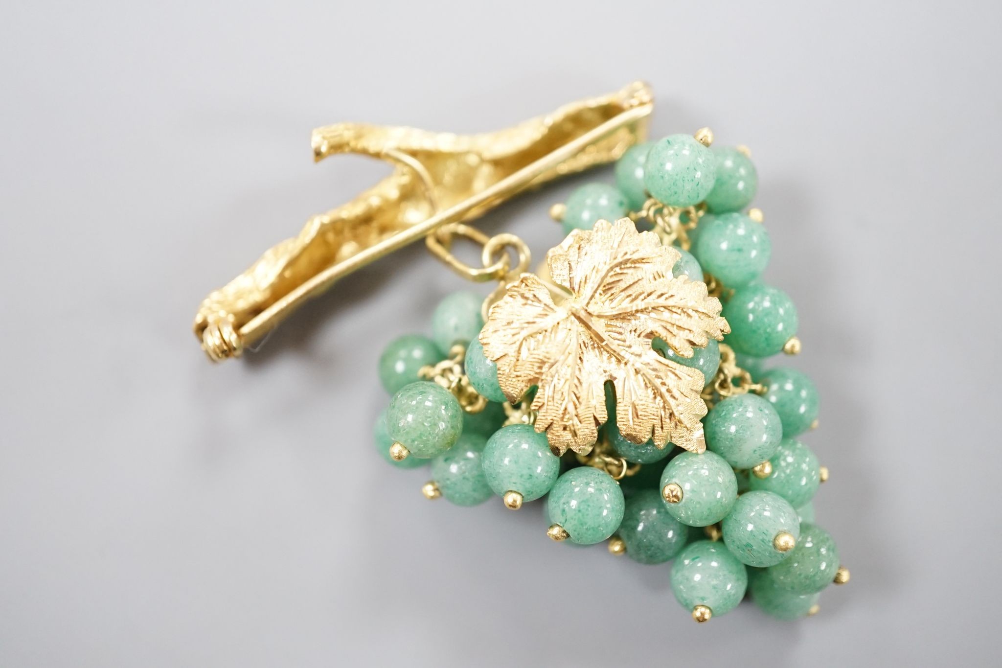 A 20th century continental 18k yellow metal and adventurine quartz bead set brooch, modelled as a bunch of grapes hanging from a branch, 59mm, gross weight 30.4 grams.